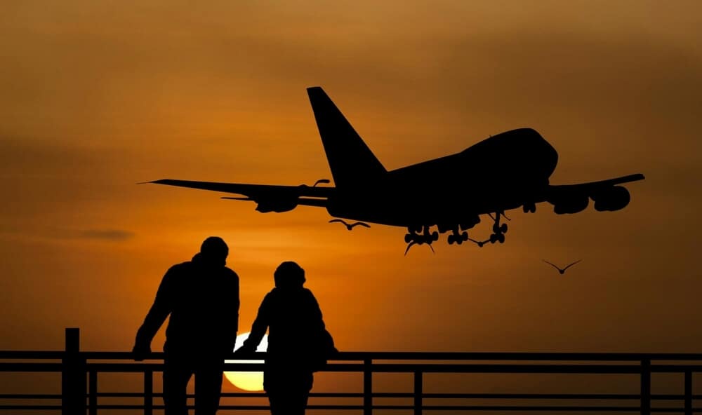 Plane in the sky during sunset, packing tips for flights