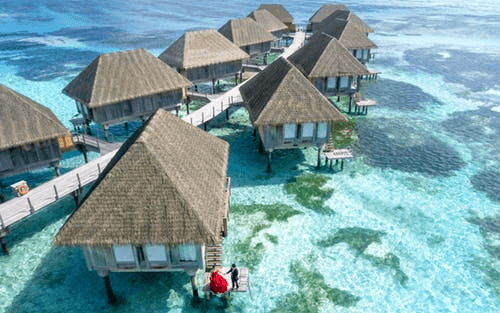 Wooden huts in Maldives, blue ocean