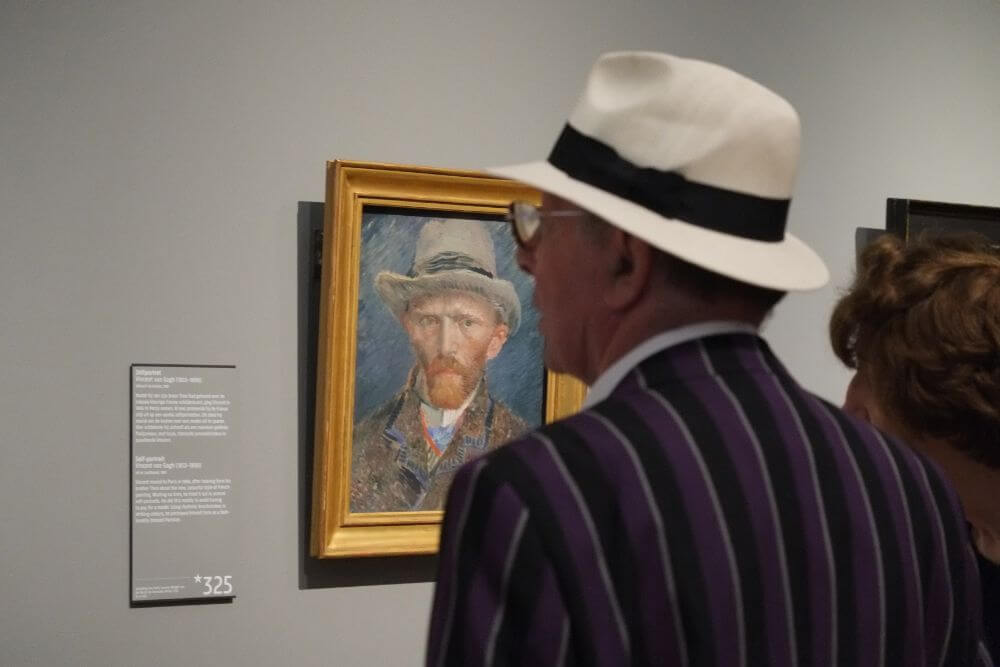 Person in Van Gogh Museum near self portrait, Amsterdam itinerary