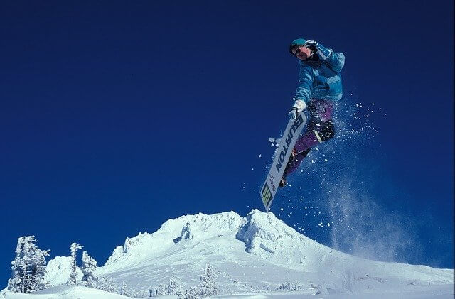 Snowboarer making tricks in French mountain ski resorts