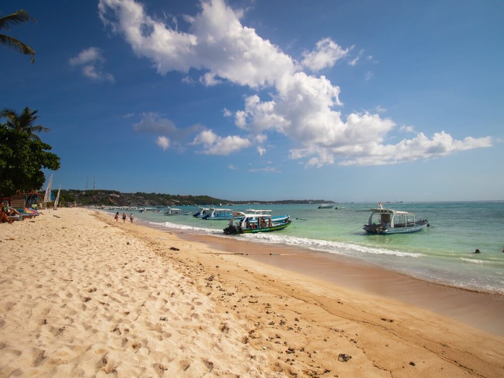 Nusa island deserted beach with boats in Southeast Asia