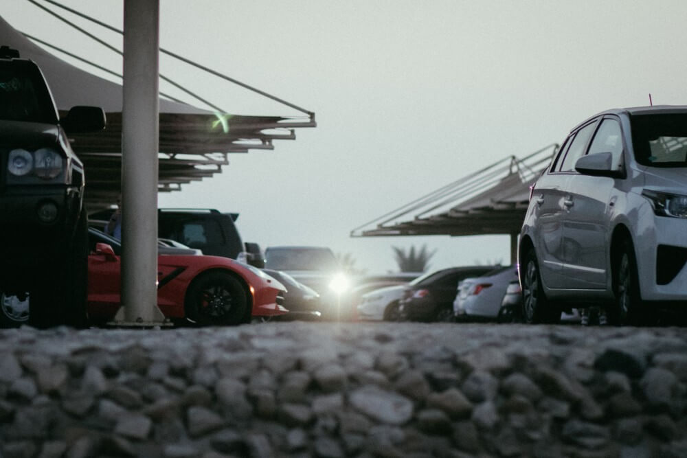 Luxury cars in a parking lot in Dubai on a cloudy day